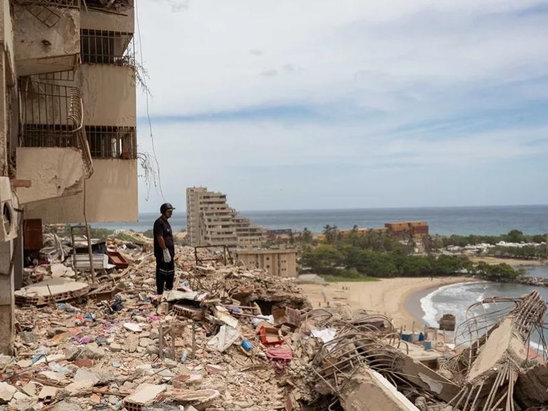 Un rescatista inspecciona los escombros en una zona afectada por los terremotos en Catia La Mar, en Venezuela. EFE/ Ronald Pena R